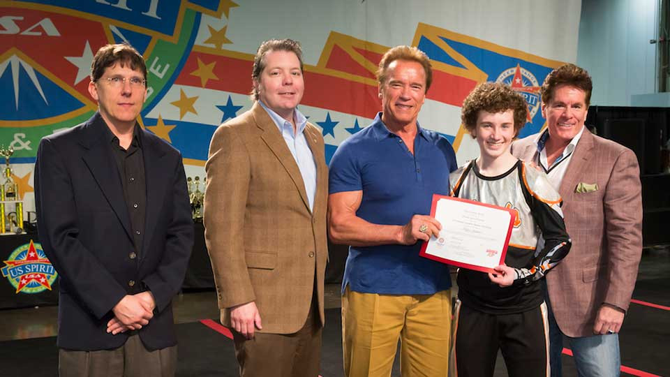 Arnold posing with group of Columbus Rotary scholarship award winners.
