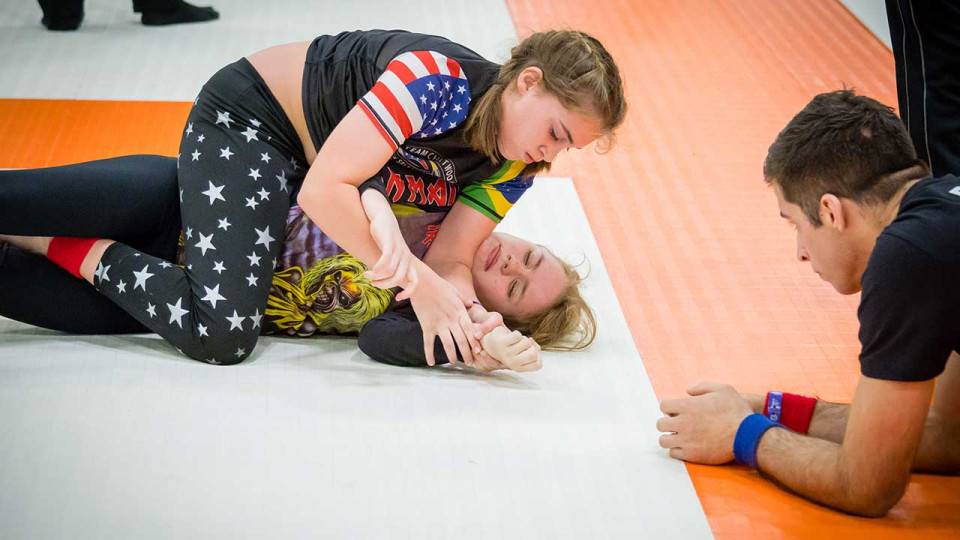 Two females in a grappling competition.